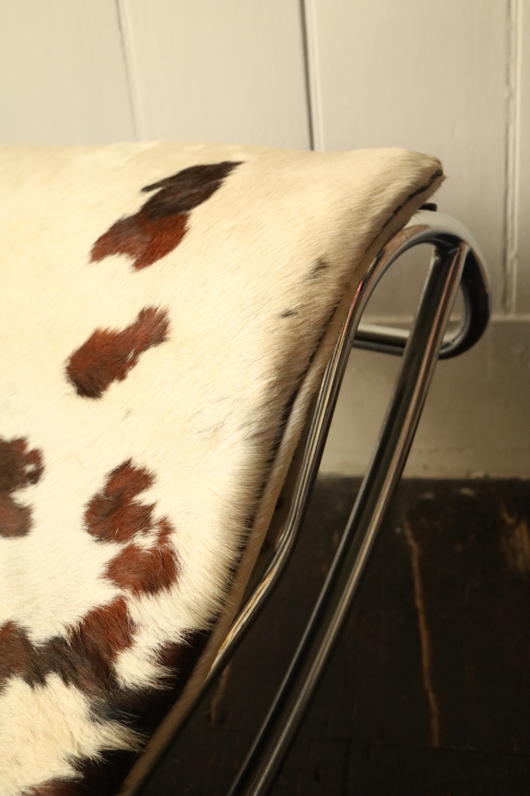 Detailed view of the headrest area on the cowhide lounger, highlighting the natural hide pattern and soft texture.
