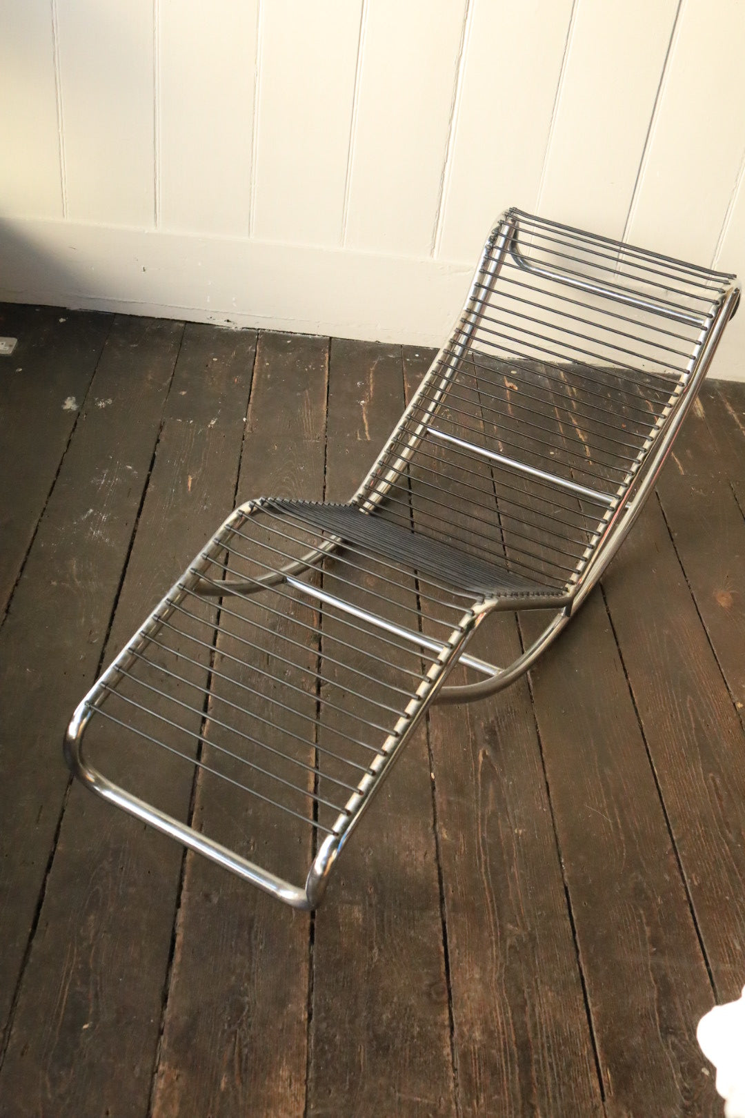 Top-down perspective of the lounger showing consistent cowhide pattern and frame connection at the sides.