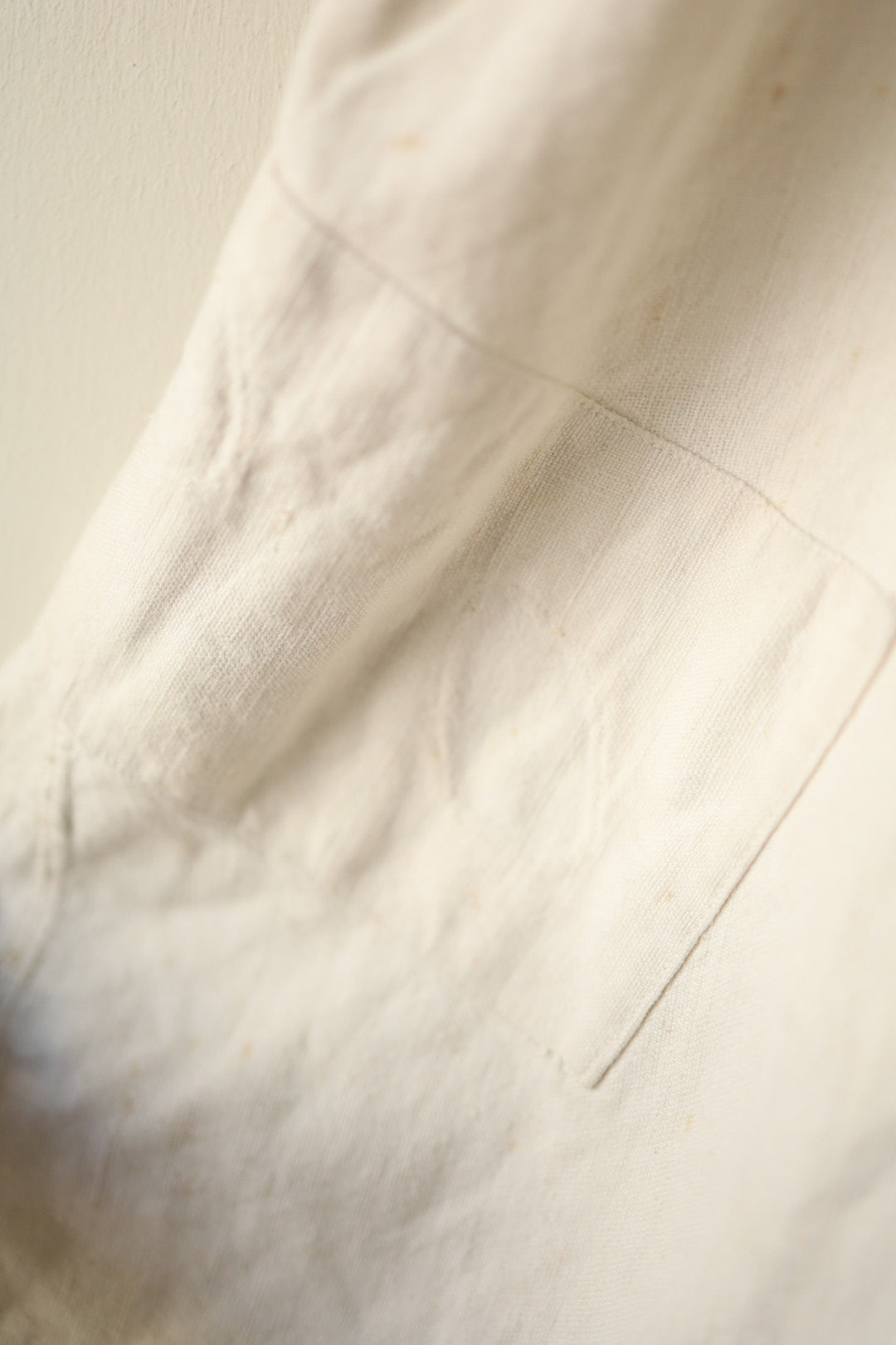 Image showing a patch repair near the pocket seam on the dress’s cream skirt.