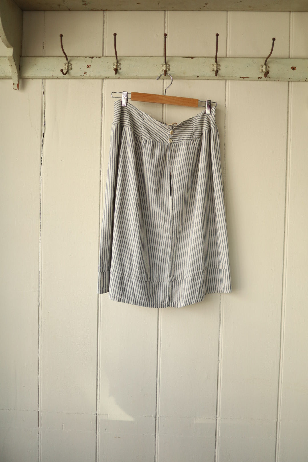 Back view of skirt with two small buttons and simple closure detail.