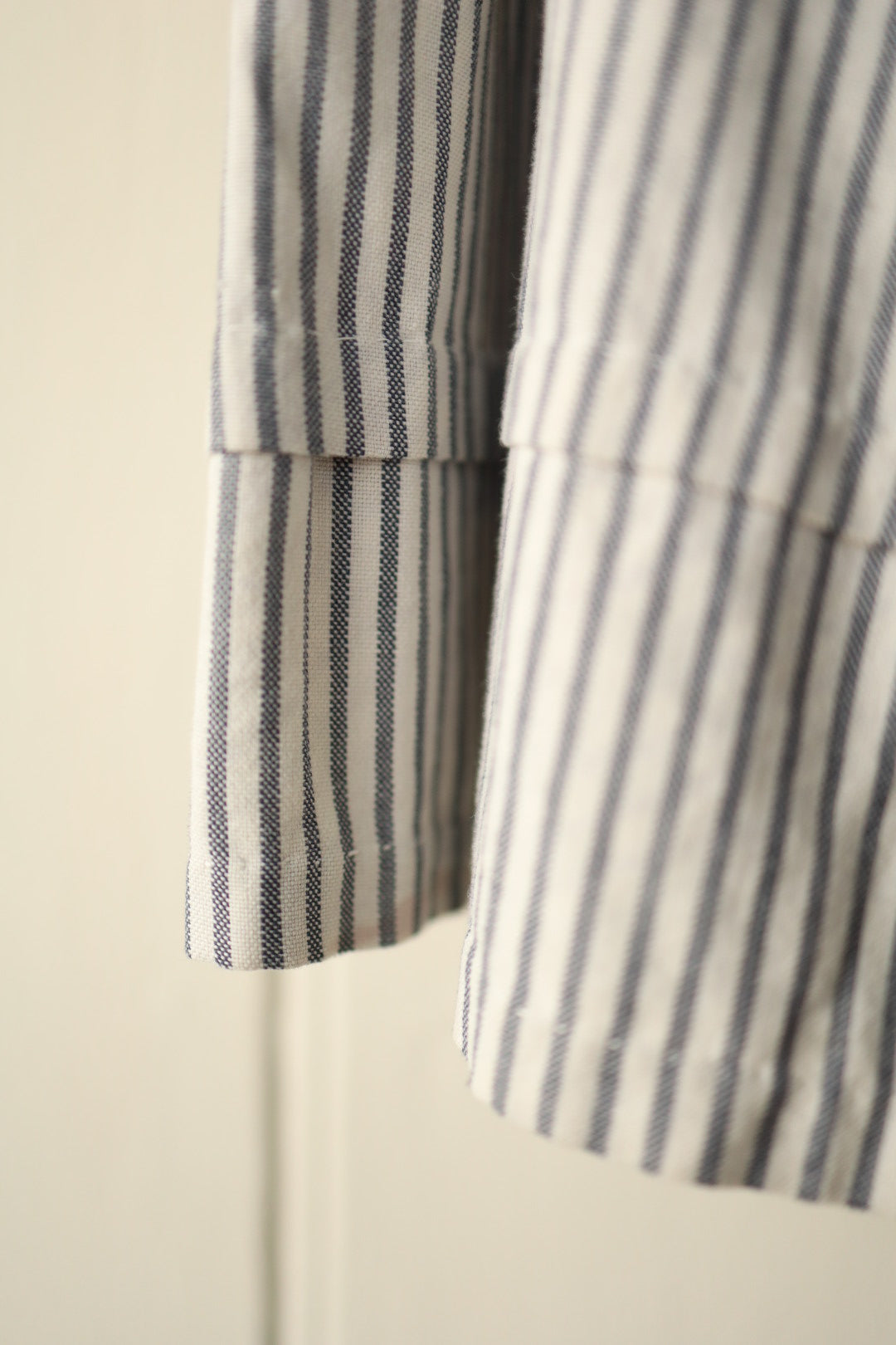 Close-up of skirt hem showing fine vertical hickory stripe and deep hem band.