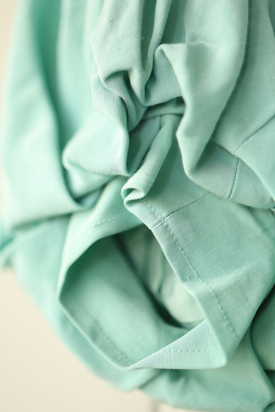 Close-up of gathered puff sleeve detailing in mint green fabric.