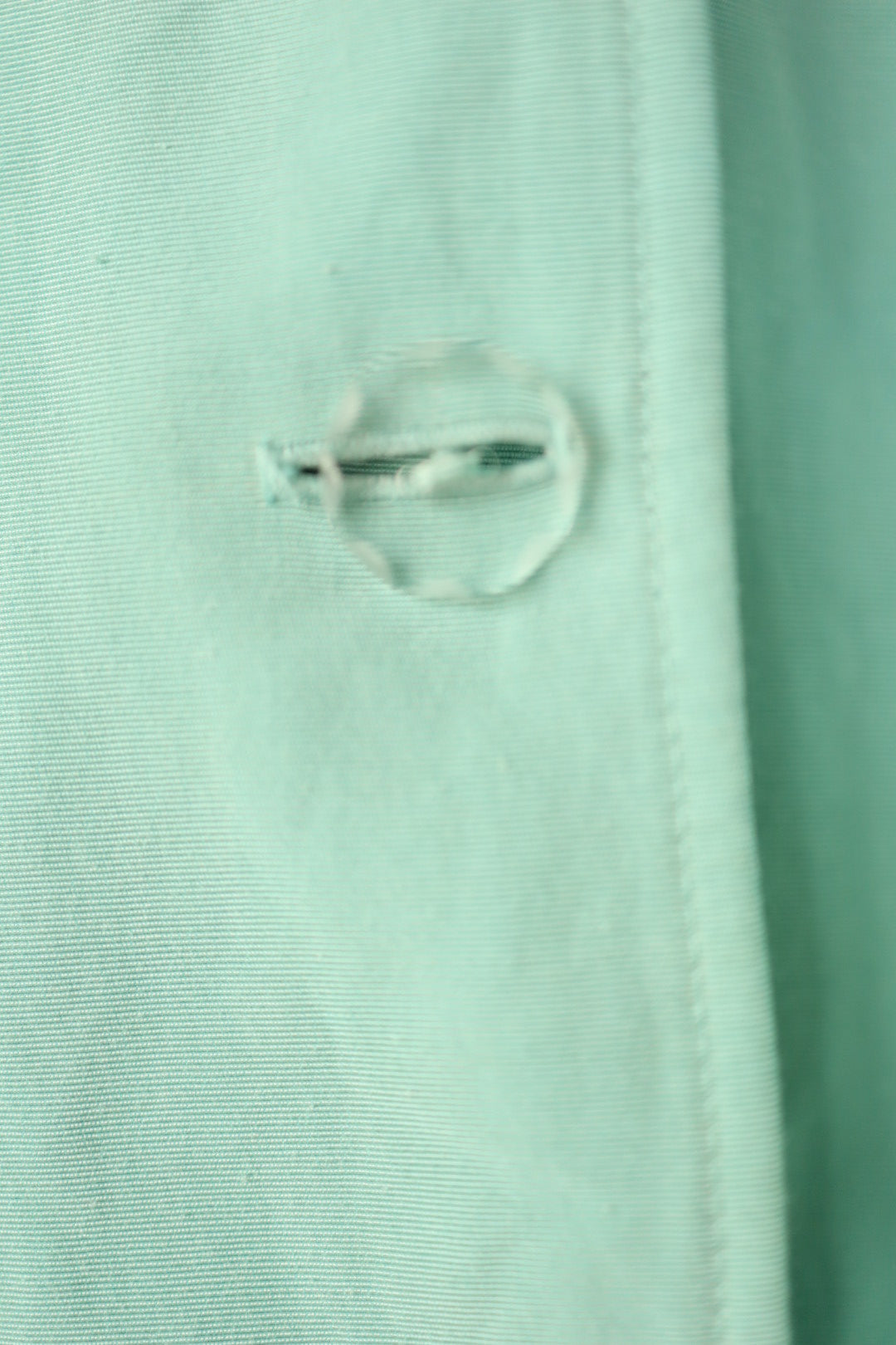 Macro shot of the buttonhole stitching on the Jean Muir jacket, showing texture and craftsmanship.