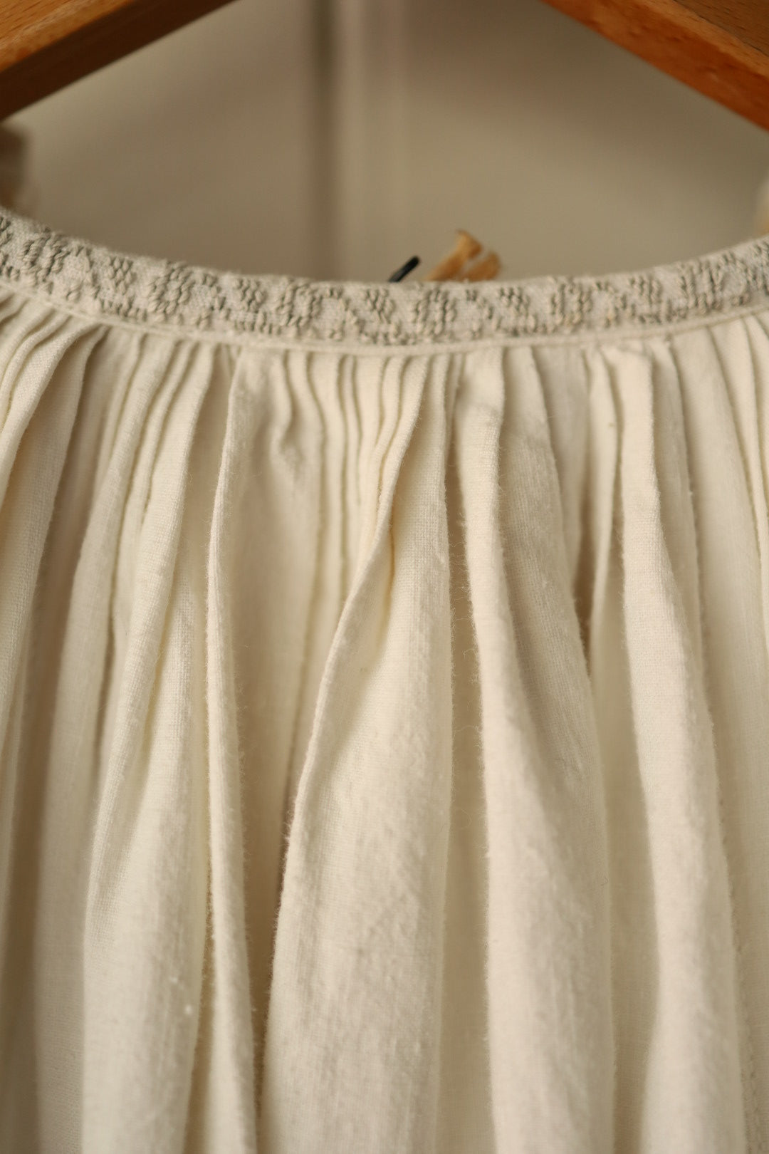 Close-up of gathered back neckline with textured stitching