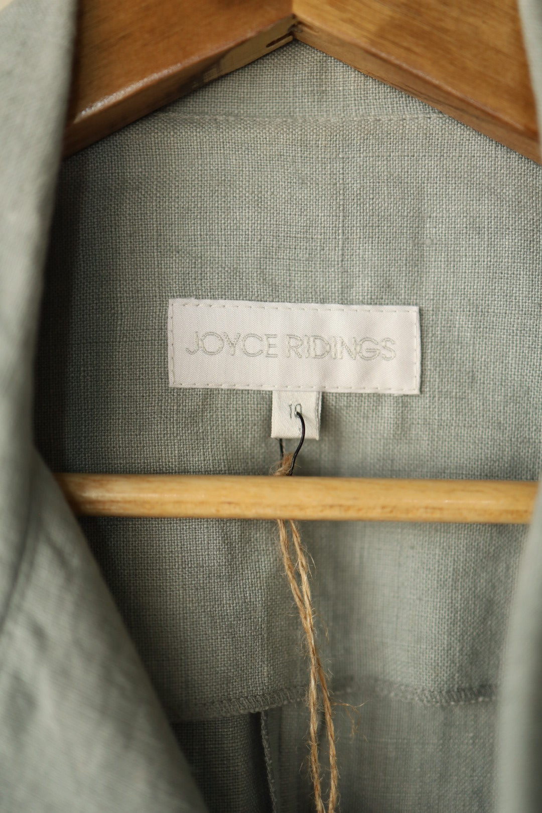 A close-up shot of the Joyce Ridings label stitched inside the jacket, with a size tag reading "10".