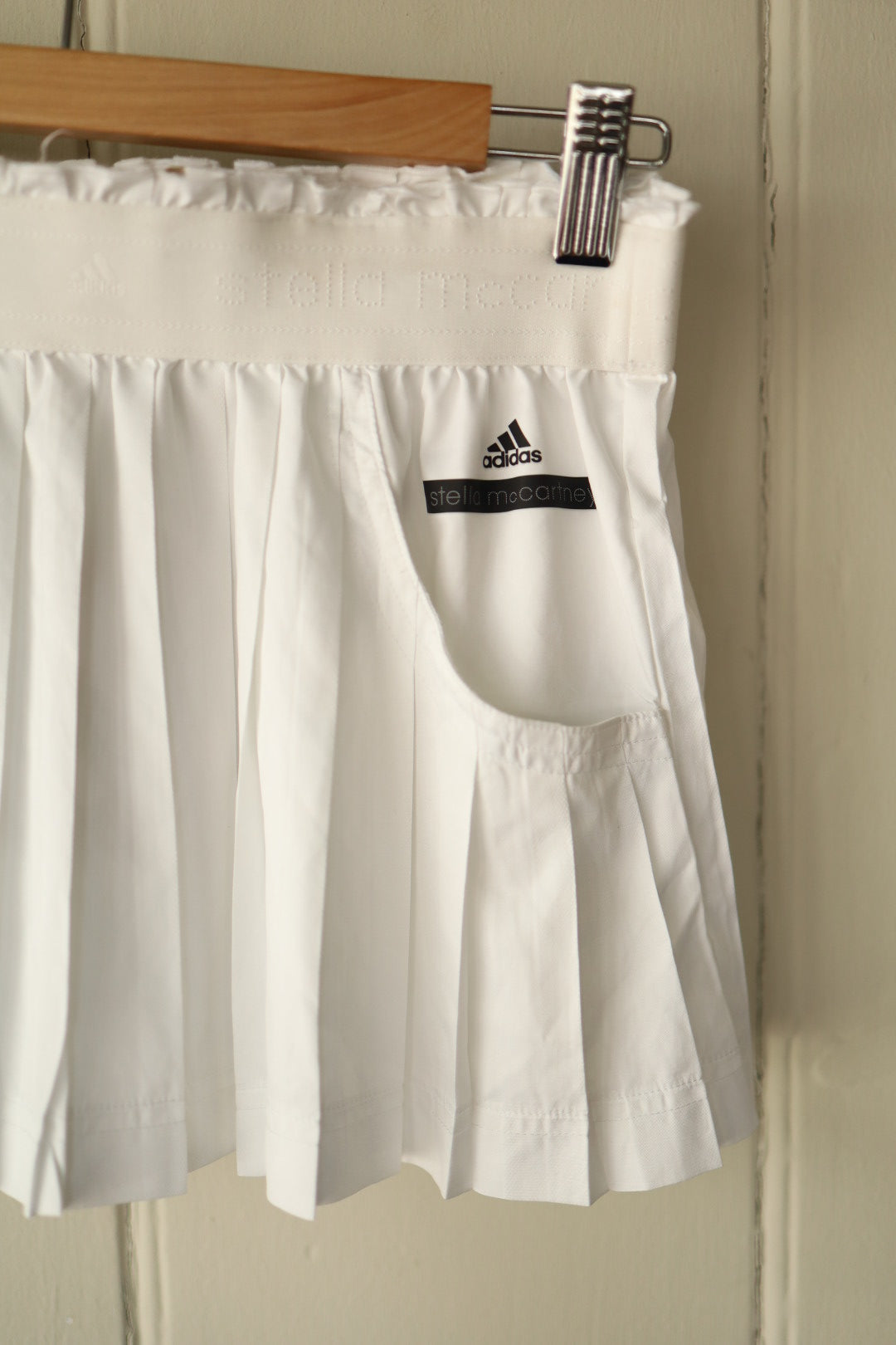 Close-up of the skirt’s front pocket featuring Adidas and Stella McCartney branding.