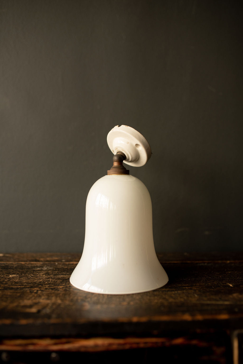 White flute shaped wall light with ceramic sconce