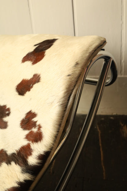 Detailed view of the headrest area on the cowhide lounger, highlighting the natural hide pattern and soft texture.
