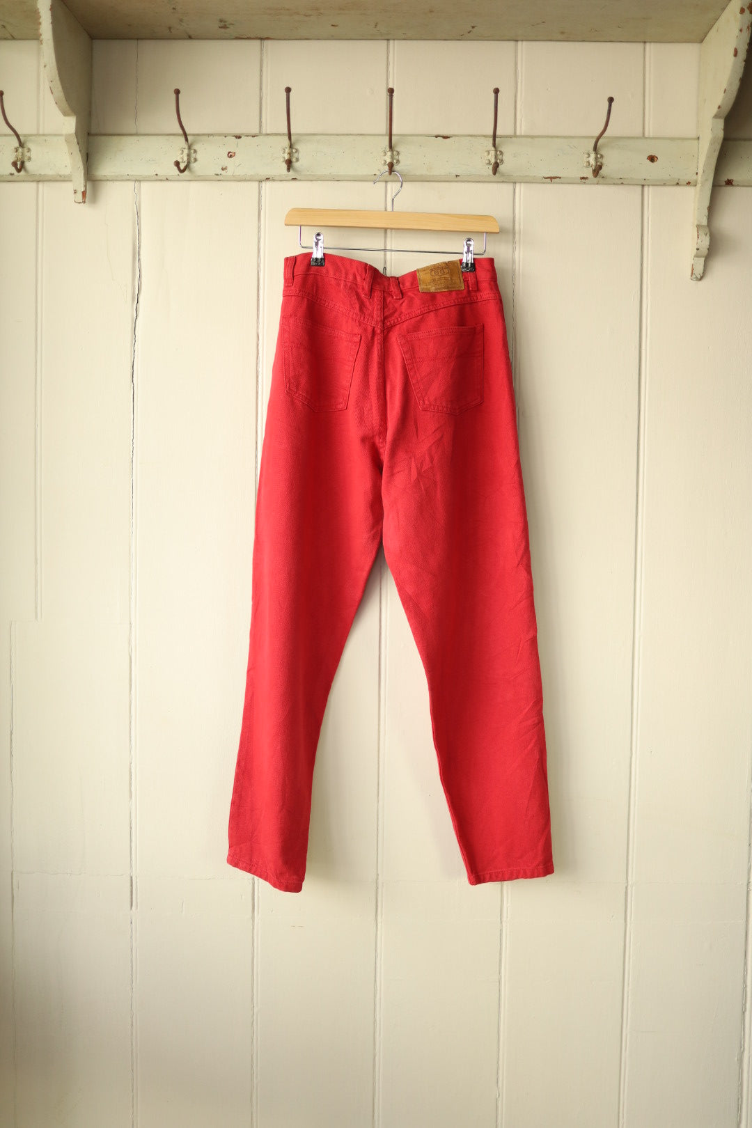 Back view of the red Route 66 jeans showing patch pockets and branded leather label on waistband.