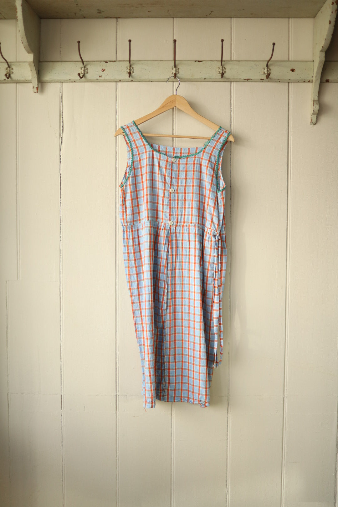 Back view of the dress showing three white buttons at the upper back and an open lower back panel with added poppers, belt loops visible at the waist.