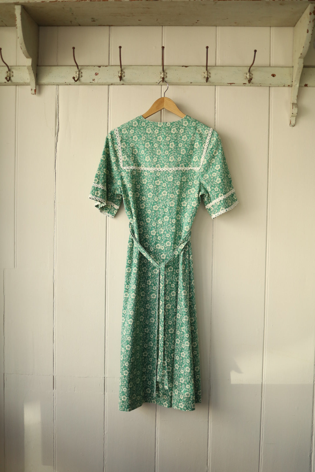 Back view showing tie waist and lace trim on sleeves and yoke