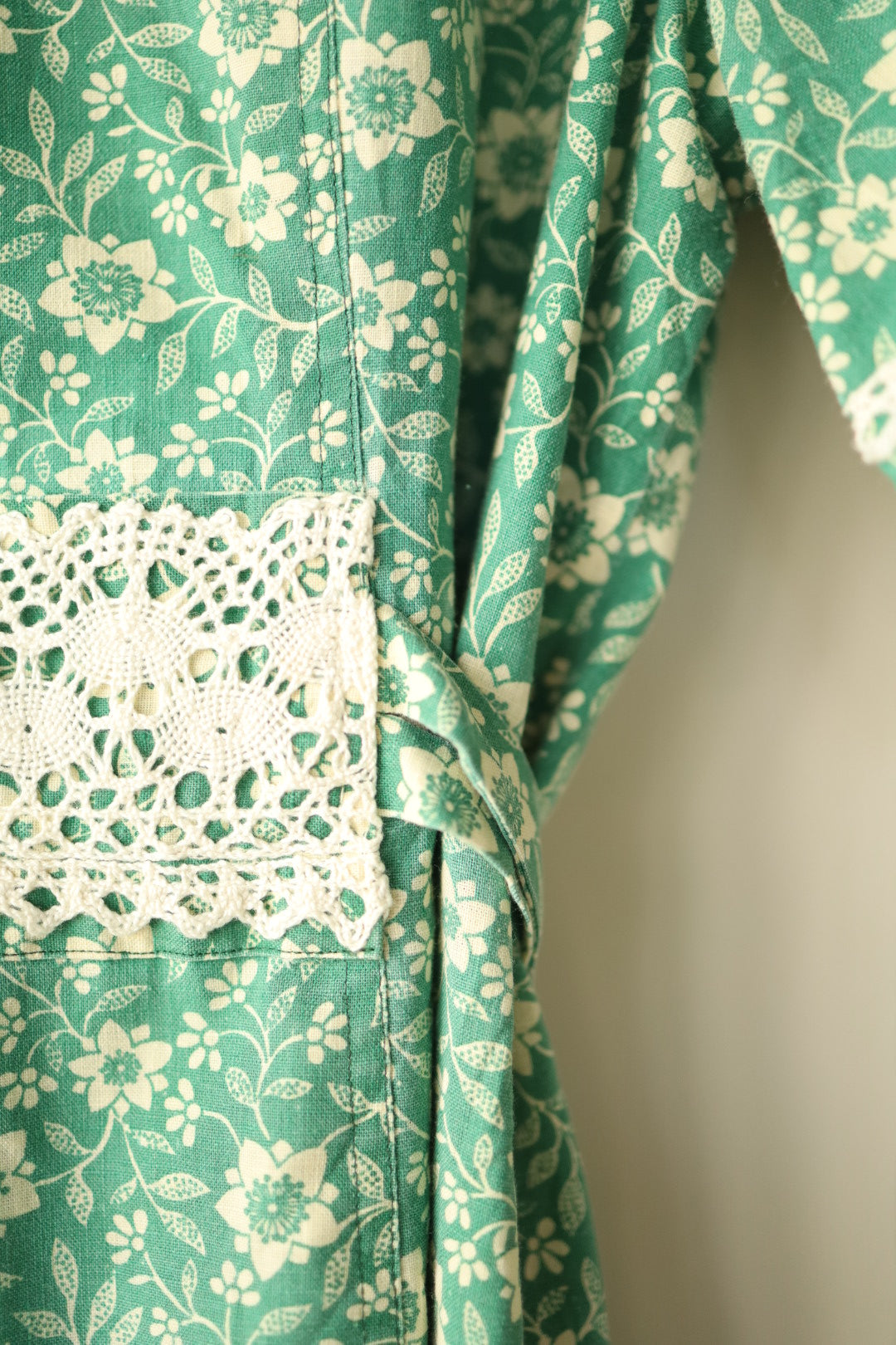 Close-up of waist lace trim and floral fabric pattern
