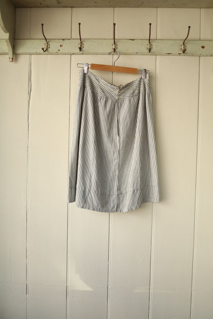 Back view of skirt with two small buttons and simple closure detail.