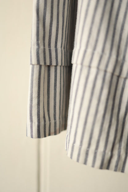 Close-up of skirt hem showing fine vertical hickory stripe and deep hem band.
