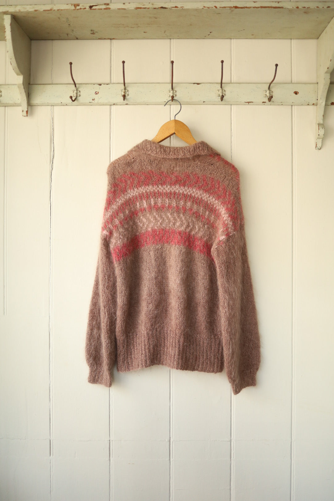 The cardigan shown from the back, highlighting the rounded intarsia pattern and soft brushed texture of the knit.