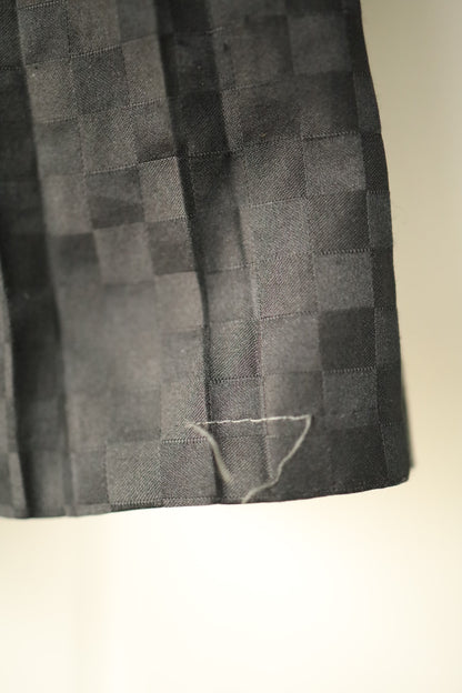 Close-up showing minor loose stitching at hem of skirt
