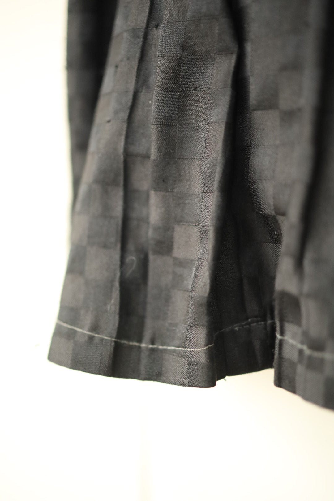 Detail of chequerboard weave texture in soft sheen fabric
