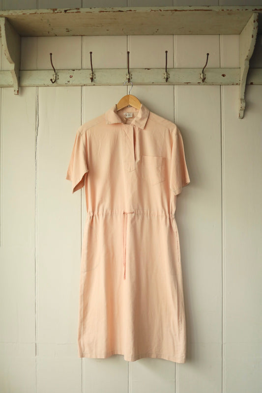Full front view of pale peach vintage shirt dress with collar and drawstring waist