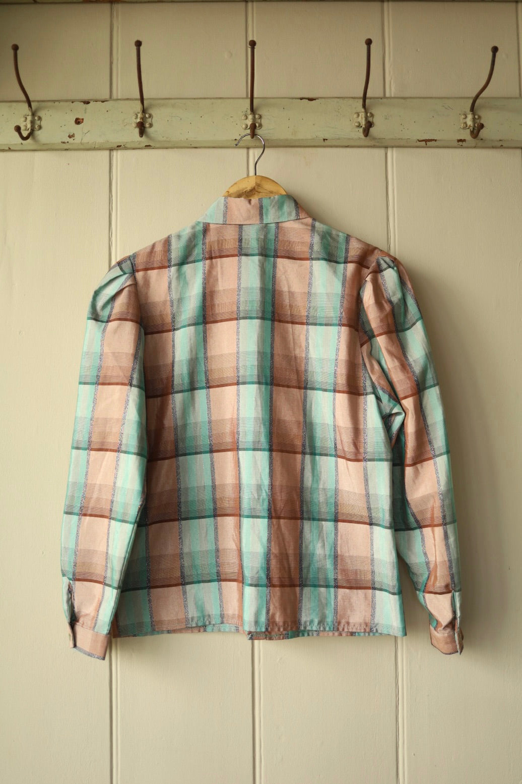 Back view of same blouse showing gathered sleeve detail and shimmer in fabric
