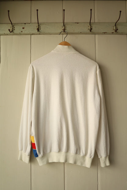 Back view of same cream tracktop showing plain velour back and ribbed hem