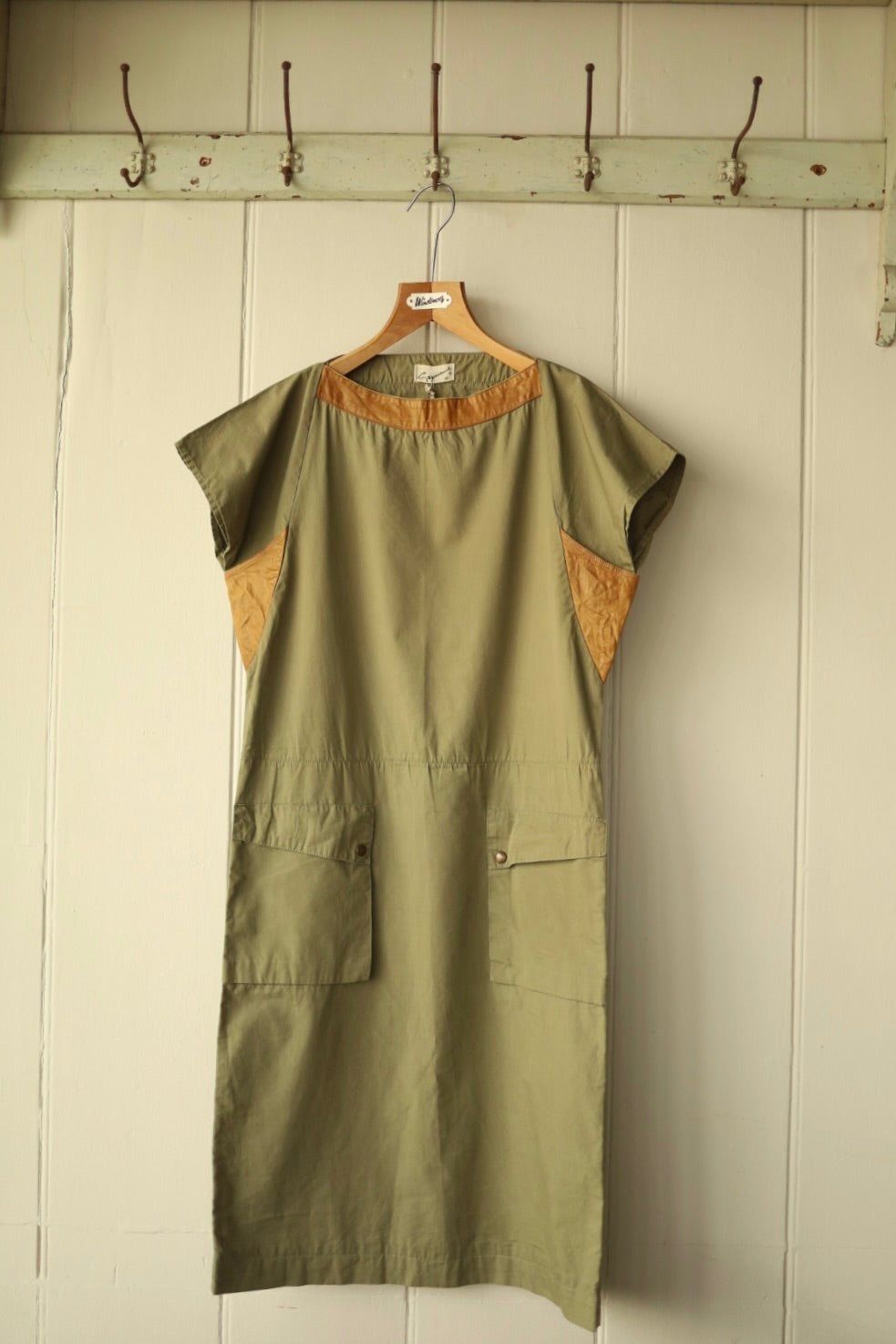Close-up front view of the same khaki dress showing neckline and pocket detailing.